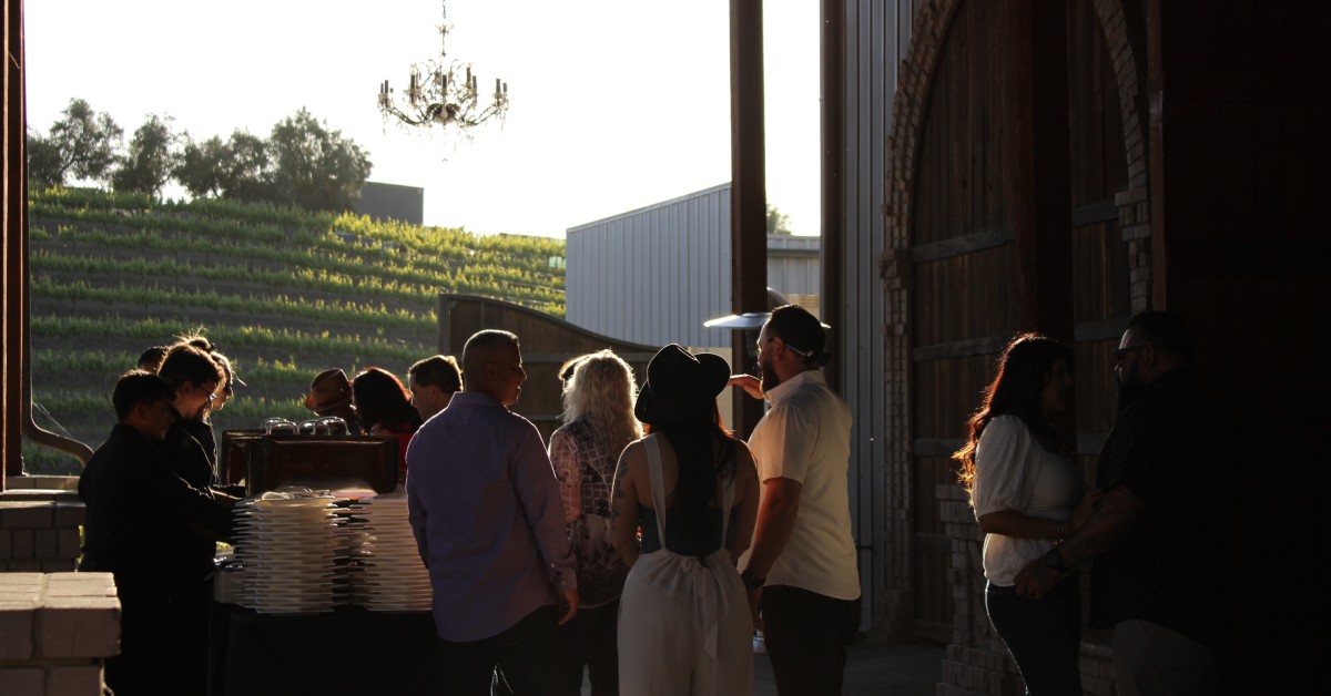 Guests mingling at an indoor winery event during a wine tasting experience in Hollister CA at Mohi Ranch