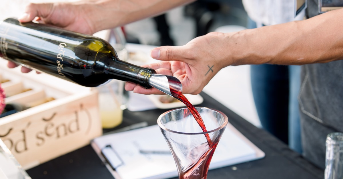 Red wine being poured during a wine tasting experience at MOHI Ranch in Morgan Hill, California