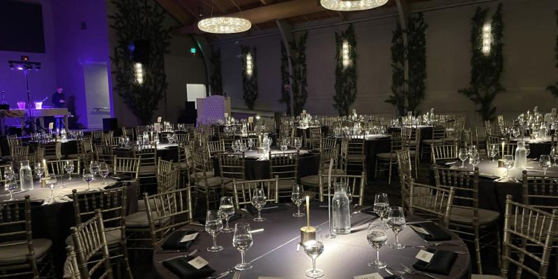 Elegant indoor corporate event setup at one of the premier event venues in California with banquet tables and ambient lighting.
