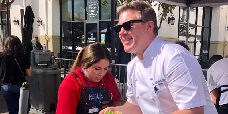Chef Tyler Florence serving food at the MOHI Food and Wine festival