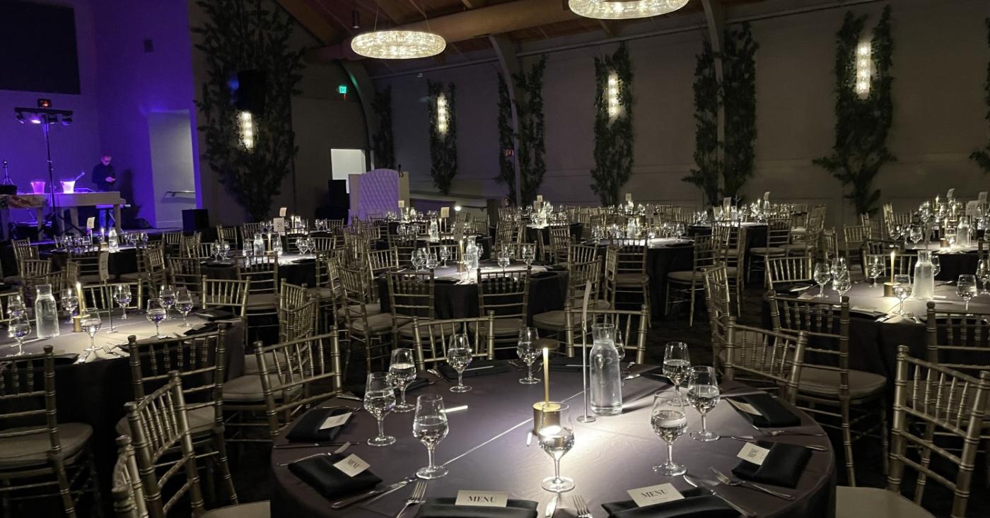 Elegant indoor corporate event setup at one of the premier event venues in California with banquet tables and ambient lighting.
