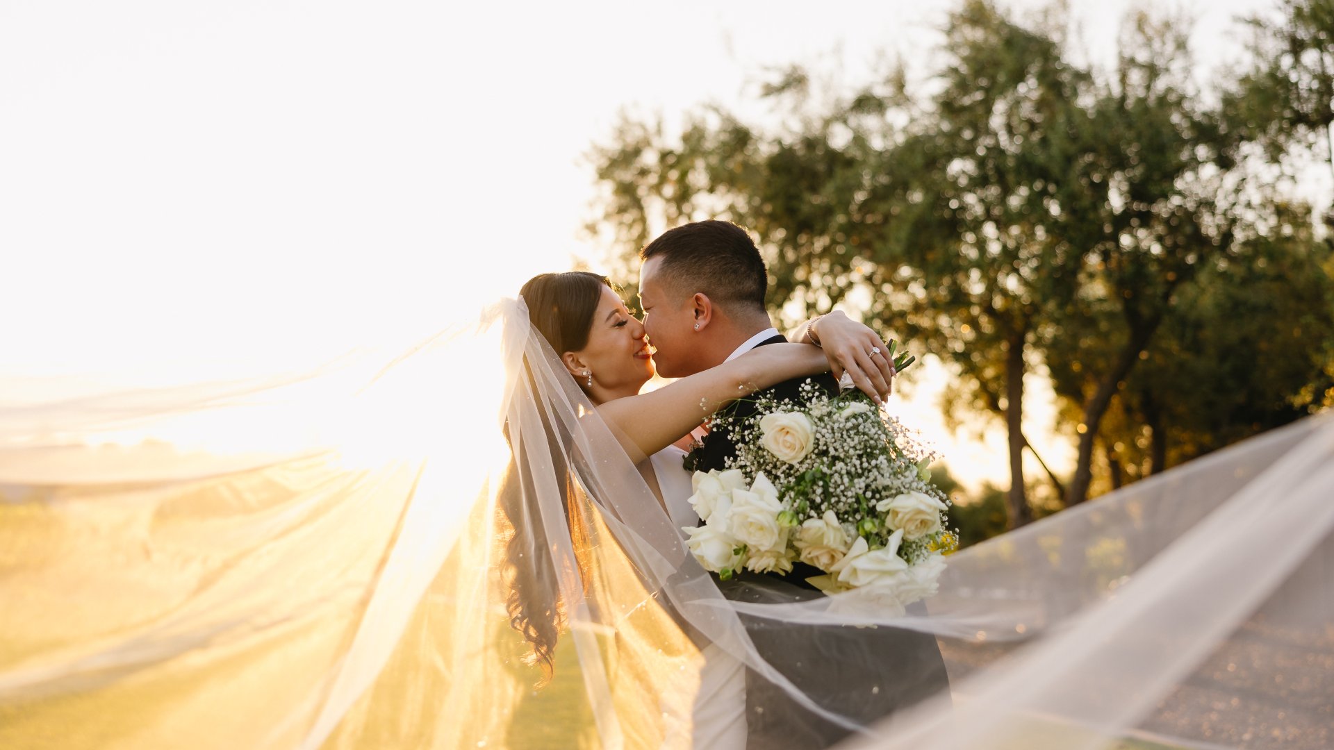Bride and groom celebrating outdoors at a vineyard, highlighting why wineries are ideal private event venues.