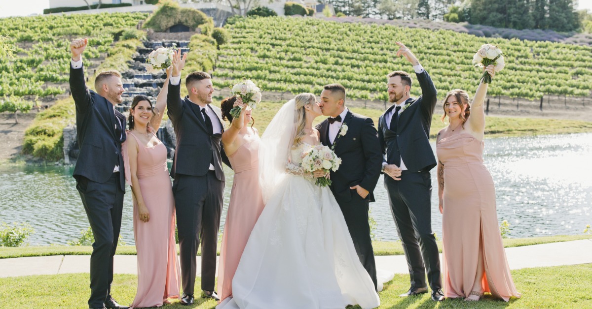 Wedding party celebrating with bride and groom at a scenic vineyard wedding venue in Hollister CA