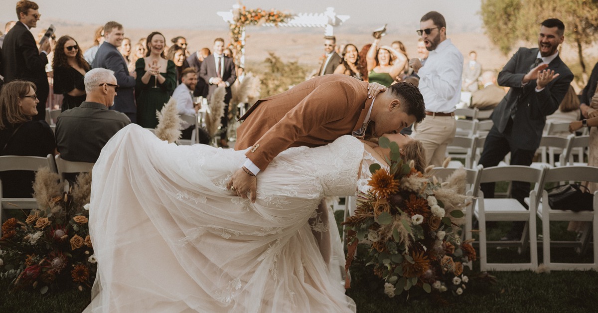 Couple celebrating wedding ceremony with guests at a California vineyard wedding
