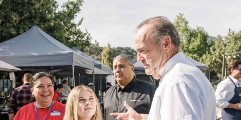 Chef Charlie Palmer serving food at the MOHI Food and Wine festival