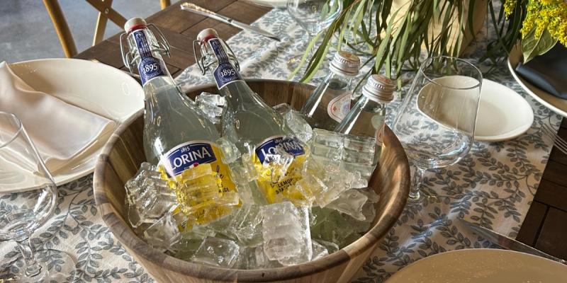 Elegant gala table setup at a California wine country private event venue with floral centerpiece and chilled sparkling beverages